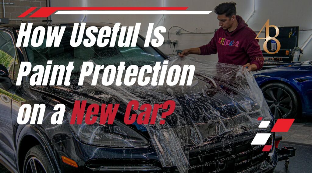 Detailing technician at 48 Detailing in Surprise, Arizona, applying a clear paint protection film to the hood of a new black SUV, demonstrating how paint protection helps safeguard against sun damage, rock chips, and road debris.