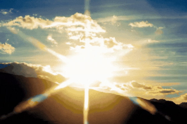 Bright Arizona sunrise over silhouetted mountains with sun rays streaming through clouds, symbolizing the environmental factors that impact ceramic coating longevity.