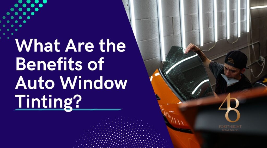 Detailer in Surprise AZ applying tint film to the side window of a bright orange car inside a shop, illustrating the benefits of auto window tinting for heat and glare reduction.