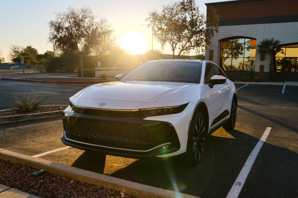A white Toyota parked in a nearly empty lot during golden hour in Surprise, Arizona, with the sun reflecting off its glossy finish—highlighting the importance of UV protection and paint preservation in a desert climate.