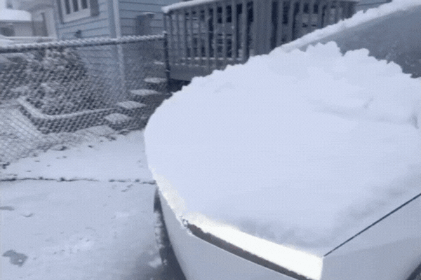 A white car covered in a thick layer of snow, parked in a residential driveway during winter, illustrating how cold weather and snow can impact vehicle surfaces if not properly maintained. This contrasts with Arizona winters, where maintaining ceramic coating in winter still matters due to different environmental challenges.