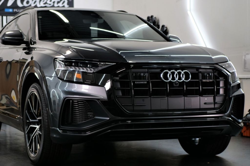 Black Audi SUV parked indoors after professional car detailing and exterior finishing