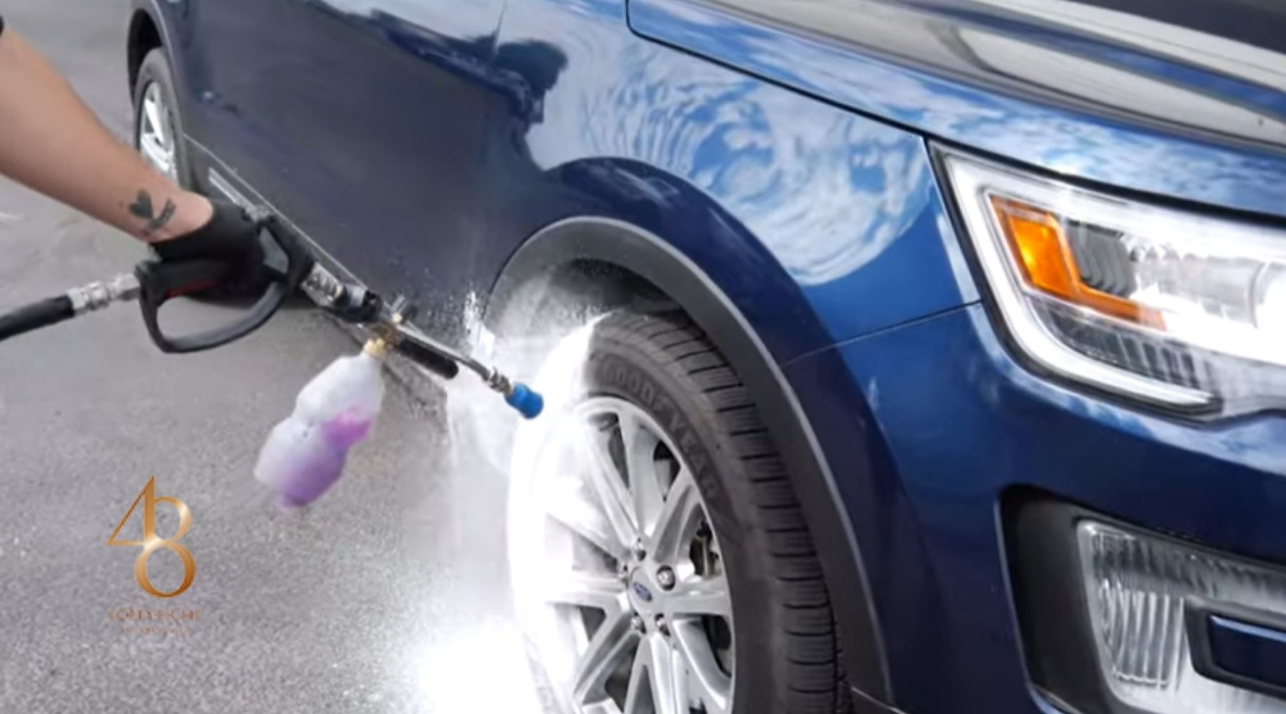 Professional car detailing wheel wash on a blue SUV in Surprise, AZ