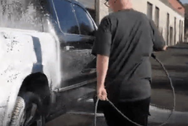 Professional exterior car wash with foam on a black vehicle in Surprise, AZ