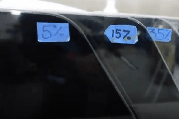 Automotive window tint samples labeled 5%, 15%, and 35% to compare different VLT darkness levels.